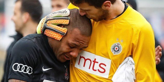 Partizan Belgrade's goalkeeper Filip Kljajic (R) hugs Brazilian midfielder Everton Luiz as he leaves the field in tears on February 19, 2017, at the end of a Serbian championship match between Partizan and Rad, after racist remarks from Rad's supporters, Serbian television B92 reported.Every time he touched the ball, 28-year-old Everton Luiz was being monkey-screamed from a group of supporters of Rad Belgrade, the source said. Shortly before the end, the match was briefly interrupted when Rad supporters also waved a banner with an insulting message against the Brazilian. / AFP / STR (Photo credit should read STR/AFP/Getty Images)