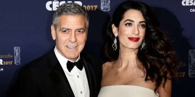 Actor George Clooney and his wife Amal pose as they arrive at the 42nd Cesar Awards ceremony in Paris, France, February 24, 2017. REUTERS/Gonzalo Fuentes