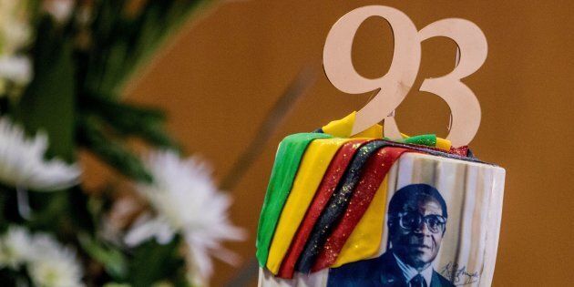 A picture taken on February 21, 2017 shows a cake bearing a portrait of Zimbabwe's President Robert Mugabe during a private ceremony to celebrate Mugabe's 93rd birthday in Harare. Mugabe, the world's oldest national ruler, turned 93, using a long and occasionally rambling interview to vow to remain in power despite growing signs of frailty. / AFP / Jekesai NJIKIZANA (Photo credit should read JEKESAI NJIKIZANA/AFP/Getty Images)