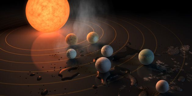 UNSPECIFIED: In this NASA digital illustration handout released on February 22, 2017, this artist's concept will appear on the February 23rd, 2017 cover of the journal Nature announcing that the TRAPPIST-1 star, an ultra-cool dwarf, has seven Earth-size planets orbiting it. Any of these planets could have liquid water on them. Planets that are farther from the star are more likely to have significant amounts of ice, especially on the side that faces away from the star. The system has been revealed through observations from NASA's Spitzer Space Telescope as well as other ground-based observatories, and the ground-based TRAPPIST telescope for which it was named after. (Photo digital Illustration by NASA/NASA via Getty Images)