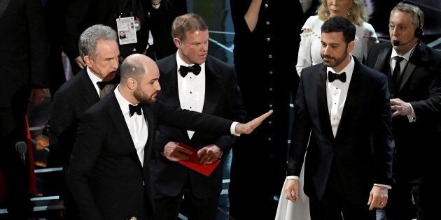 HOLLYWOOD, CA - FEBRUARY 26: 'La La Land' producer Jordan Horowitz (C) stops the show to announce the actual Best Picture winner as 'Moonlight' following a presentation error with actor Warren Beatty (L) and host Jimmy Kimmel (R) onstage during the 89th Annual Academy Awards at Hollywood & Highland Center on February 26, 2017 in Hollywood, California. (Photo by Kevin Winter/Getty Images)