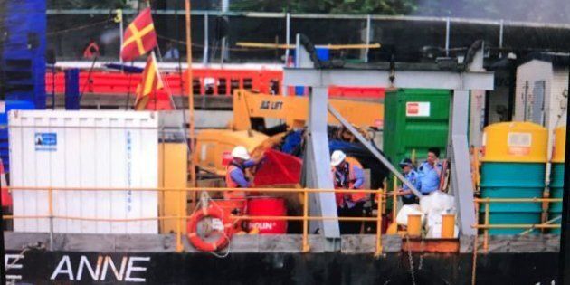 Police and workers gather on a barge where a man died at Barangaroo. Photo: David Porter