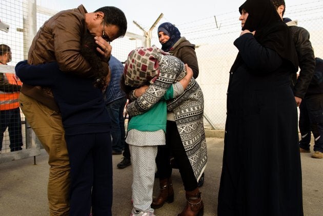 Refugees, who are members of the same family and were seperated due to the conflict in their countries, hug as they are reunited at the Kokkinotrimithia refugee camp, some 20 kilometres outside the Cypriot capital Nicosia, on February 4, 2017.