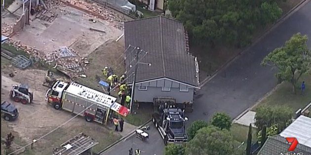 The 26-year-old became wedged between the house and the removalist truck.