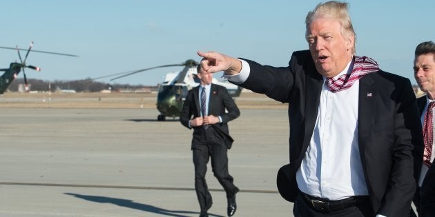 US President Donald Trump waves to wellwishers after stepping off Air Force One at Andrews Air Force Base in Maryland upon his return from Philadelphia on January 26, 2017.Donald Trump made his maiden voyage outside the Washington area as US president Thursday, meeting with lawmakers to map out their 2017 policy strategy and smooth emerging differences between the White House and congressional Republicans. / AFP / NICHOLAS KAMM (Photo credit should read NICHOLAS KAMM/AFP/Getty Images)