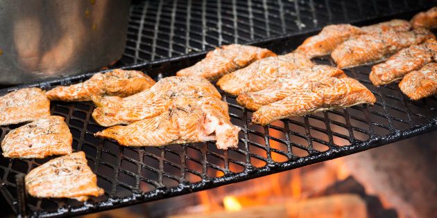 Fresh coho salmon cooking on an outdoor grill, Juneau, Alaska, USA