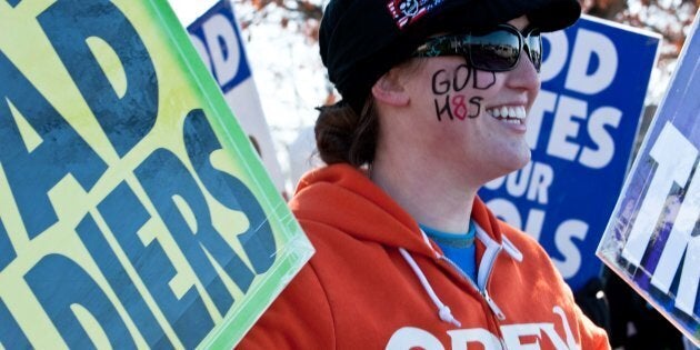 Megan Phelps-Roper of the Westboro Baptist Church, a Kansas church known for its vehement anti-gay positions and for protesting at US soldiers' funeral, stage a protest across the street from Northwestern High School in Hyattsville, Maryland, outside Washington, on March 1, 2011. The church was demonstrating against what it claims is a 'pervert-run' school and said teachers across the country have 'broken the moral compass of this generation.' AFP PHOTO/Nicholas KAMM (Photo credit should read NICHOLAS KAMM/AFP/Getty Images)