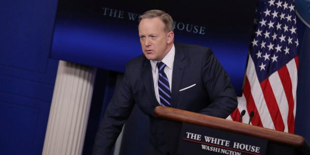 Sean Spicer with his piles of paper