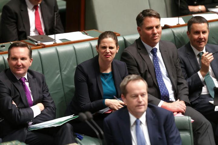 Shadow Education Minister Kate Ellis listens as Prime Minister Tony Abbott speaks during Question Time on Wednesday 16 July 2014