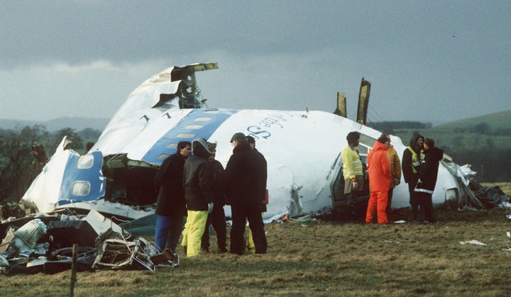 Emergency service workers are seen next to the wreckage of Pan Am flight 103, in a farmer's field east of Lockerbie, Scotland.