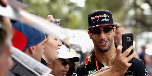 Australia's Daniel Ricciardo poses for a photo with fans ahead of the Australian Formula One Grand Prix at Albert Park.