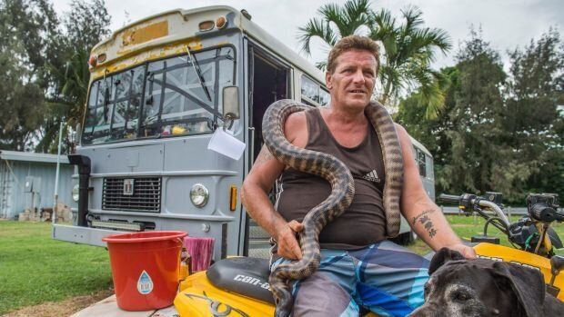 Shane Borgas says his can't leave his two pythons, Great Dane and the 1981 school bus he calls home.