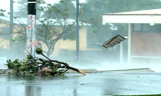 A 'Keep Left' sign flies down the street after being ripped from it's post by the Category 4 winds.