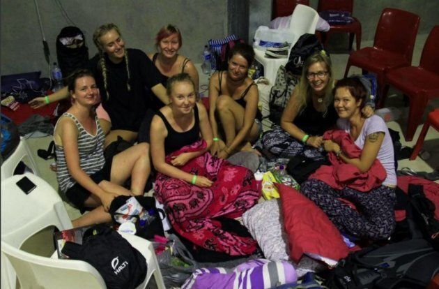 Backpackers shelter at an evacuation centre in Ayr as Debbie builds offshore on Tuesday.