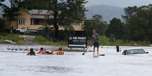 Locals paddle down the main street of Billinudgel in NSW.