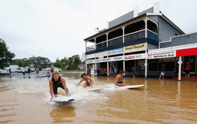 BILLINUDGEL, AUSTRALIA - MARCH 31: Local residents surf down the main street on March 31, 2017 in Billinudgel,...