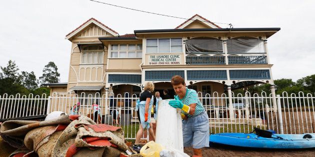 Residents help to clean up the Lismore Medical clinic after the floods