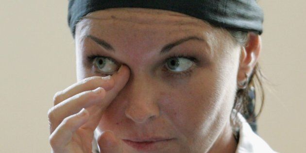 Schappelle Corby wipes her eye during a court hearing in Denpasar District Court in 2006.