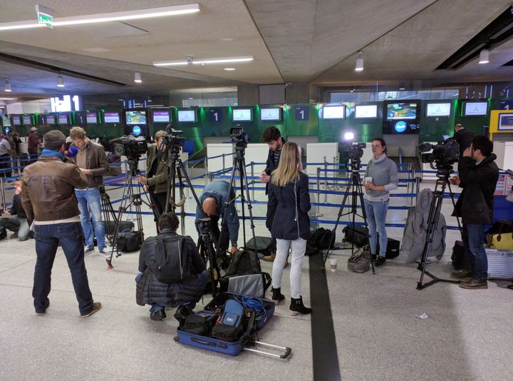 Reporters gather at Charles de Gaulle Airport outside of Paris.
