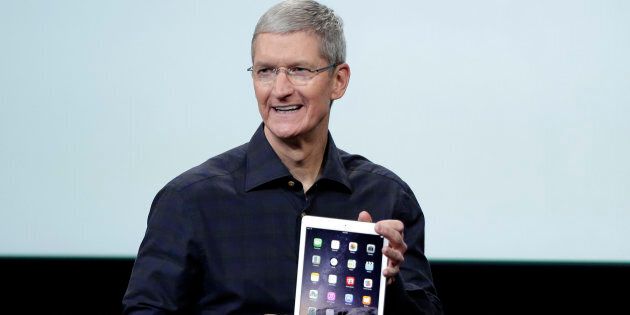 Apple CEO Tim Cook holds an iPad Air 2.