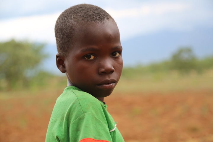 Precious Lameck, 13, pictured in his family's dried up garden.