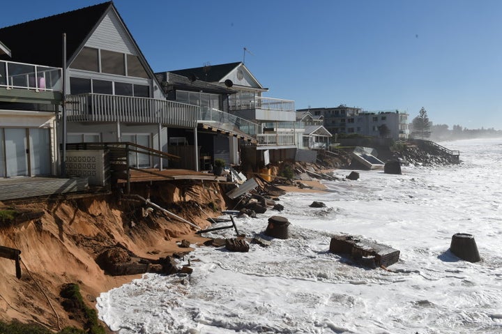 High tide begins to impact on damaged beachfront homes along Pittwater Road at Collaroy.