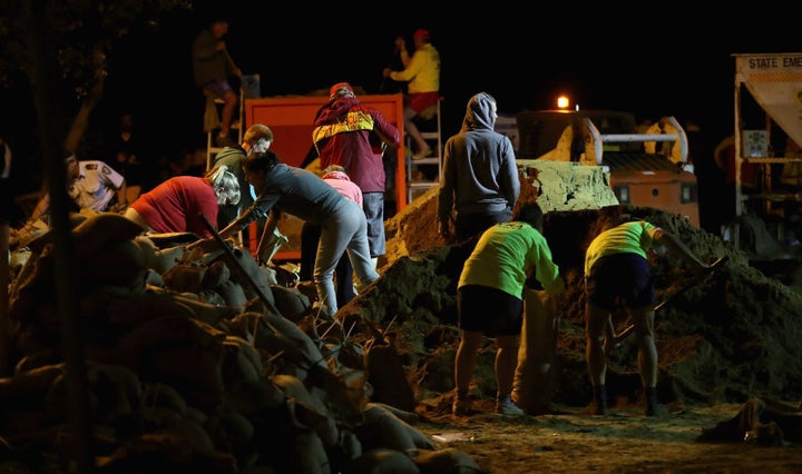 NSW Rural Fire Service workers, NSW State Emergency Service, Surf Lifesavers, Northern Beaches Council workers sandbagged through the night.