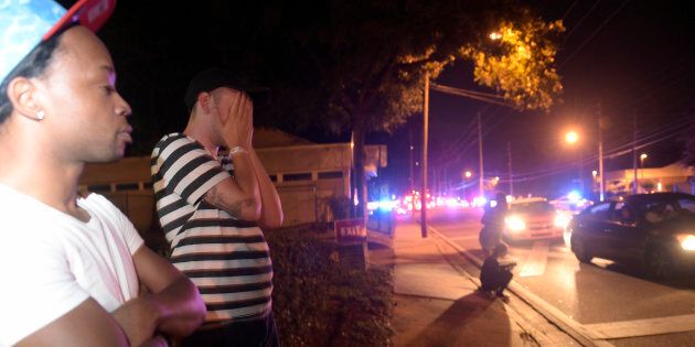 Jermaine Towns, left, and Brandon Shuford wait down the street Pulse nightclub in Orlando, Florida. Towns said his brother was in the club when a gunman opened fire.
