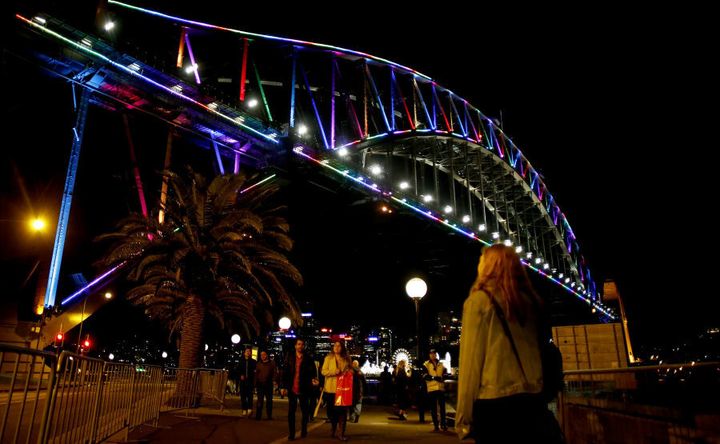 The Sydney Harbour Bridge is lit in rainbow colours.