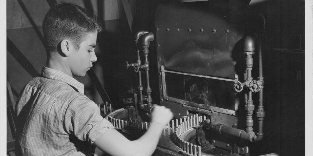 A young boy working in a war factory 1940-45.