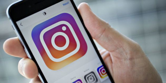 Facebook Inc.'s Instagram application is demonstrated on an Apple Inc. iPhone in this arranged photograph taken in Washington, D.C., U.S., on Friday, June 17, 2016. In a bid to give its users an incentive to create more content for the photo and video-sharing site, Facebook's Instagram is considering sharing revenue generated from news, sports, celebrities and other content said Carolyn Everson, vice president for global marketing solutions at Facebook. Photographer: Andrew Harrer/Bloomberg via Getty Images