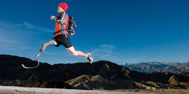 An athlete with a prosthetic leg in mid-air, training for the paralympics.