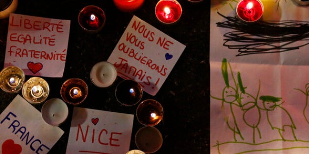 Burning candles, messages and a drawing pay tribute to victims of the truck attack along the Promenade des Anglais on Bastille Day that killed scores and injured as many in Nice, France, July 17, 2016. REUTERS/Pascal Rossignol