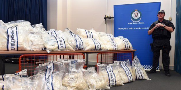 An Australian Federal Police officer stands guard over some of the seized drugs in one of the largest drug busts in the country's history, worth up to $1.28 billion USD, in Sydney on November 29, 2014.