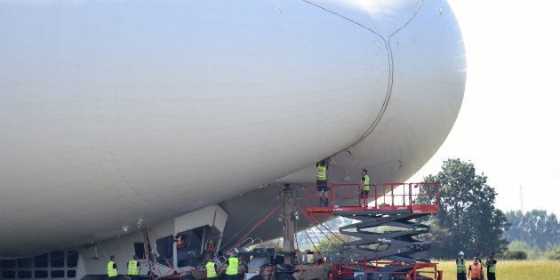 The Hybrid Air Vehicles HAV 304 Airlander 10 hybrid airship is seen in the air on its maiden flight at Cardington Airfield near Bedford, north of London, on August 17, 2016. The Hybrid Air Vehicles 92-metre long, 43.5-metre wide Airlander 10, billed as the world's longest aircraft, lifted off for the first time from an airfield north of London. The Airlander 10 has a large helium-filled fabric hull and is propelled by four turbocharged diesel engines. According to the company it can stay airborne for up to five days at a time if manned, and for over 2 weeks unmanned with a cruising speed of just under 150 km per hour and a payload capacity of up to 10,000 kg. / AFP / JUSTIN TALLIS (Photo credit should read JUSTIN TALLIS/AFP/Getty Images)