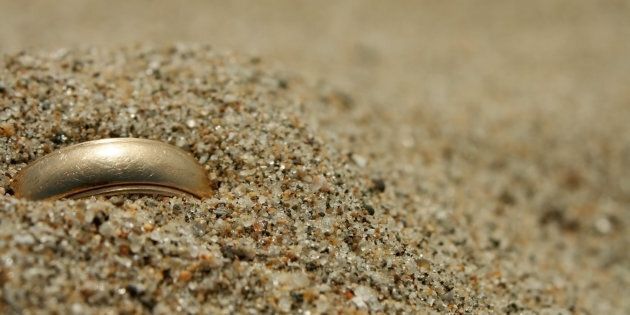 A gold ring lost in the sand.