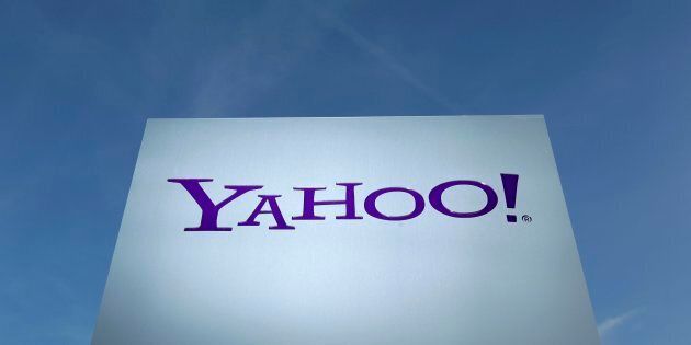 A Yahoo logo is pictured in front of a building in Rolle, 30 km (19 miles) east of Geneva, Switzerland on December 12, 2012. REUTERS/Denis Balibouse/File Photo
