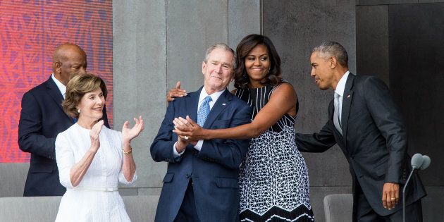 TOPSHOT - (L-R) Former US First Lady Laura Bush, former US President George W. Bush, First Lady Michelle Obama, and President Barack Obama attend the opening ceremony for the Smithsonian National Museum of African American History and Culture on September 24, 2016 in Washington, D.C. / AFP / ZACH GIBSON (Photo credit should read ZACH GIBSON/AFP/Getty Images)