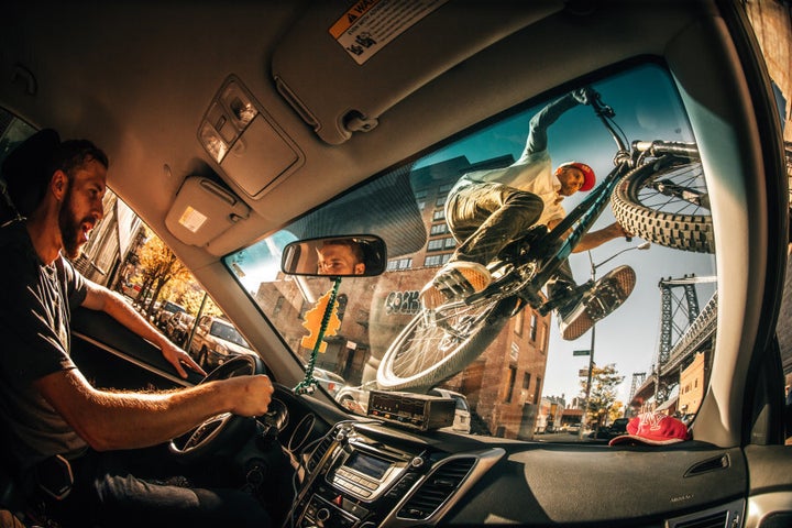 Ale Di Lullo's fun shot of Aaron Chase riding his mountain bike on the windshield of a NYC cab.