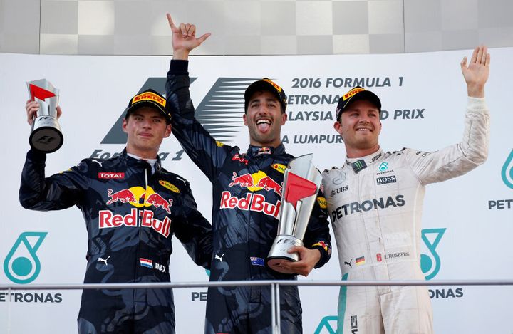 Ricciardo, Max Verstappen and Nico Rosberg celebrate on the podium after the Malaysian Grand Prix