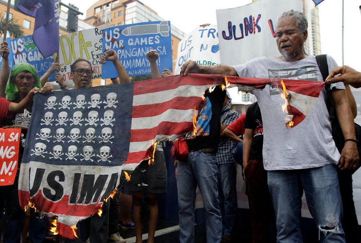 Demonstrators burn a mock U.S. flag during a rally opposing the U.S.-Philippines joint military exercises outside the U.S. embassy in Manila, Philippines, on October 4