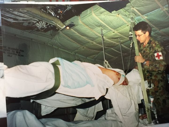 Read tends to a patient on the back of a Hercules C-130.