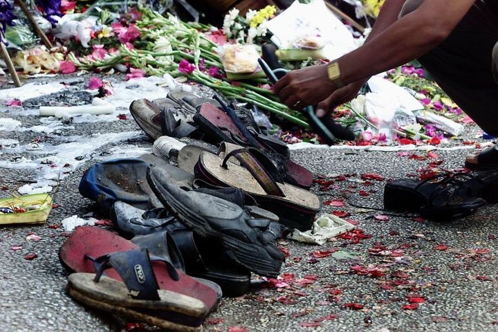 Shoes found at the remains of The Sari Club are placed by a shrine in October 2002.