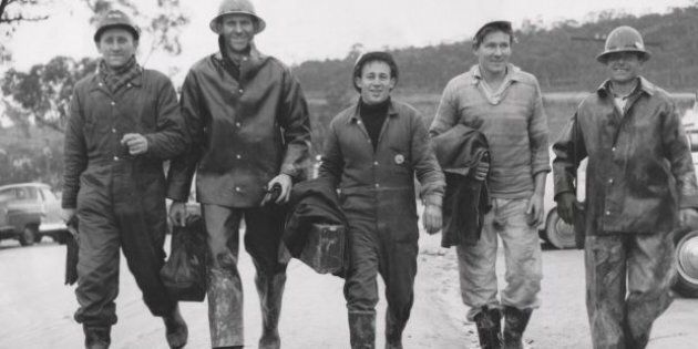 Workers return after a day's work in June 1957 on the snowy mountains.