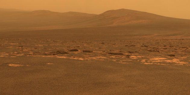 A portion of the west rim of Endeavour crater sweeps southward in this color view from NASA's Mars Exploration Rover Opportunity released by NASA August 10, 2011. This crater has a diameter of about 14 miles (22 km). This view combines exposures taken by Opportunity's panoramic camera (Pancam) of the rover's work on Mars August 6, 2011. Opportunity arrived at the rim during its next drive on August 9, 2011. Endeavour crater has been the rover team's destination for Opportunity since the rover finished exploring Victoria crater in August 2008. Endeavour offers access to older geological deposits than any Opportunity has seen before. The lighter-toned rocks closer to the rover in this view are similar to the rocks Opportunity has driven over for most of the mission. However, the darker-toned and rougher rocks just beyond that might be a different type for Opportunity to investigate. The ground in the foreground is covered with iron-rich spherules, nicknamed