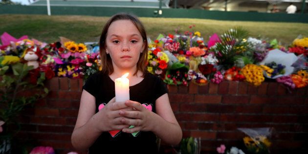 Ella Cowen attends a candlelit vigil outside Dreamworld on the Gold Coast, Queensland.