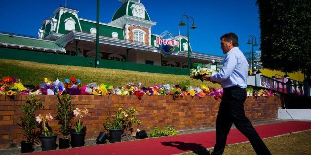 Dreamworld CEO Craig Davidson lays flowers at a floral tribute on Tuesday.