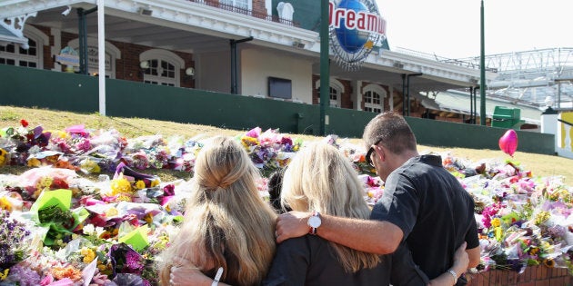 Staff members paid tribute to the victims and their families outside Dreamworld on Friday.