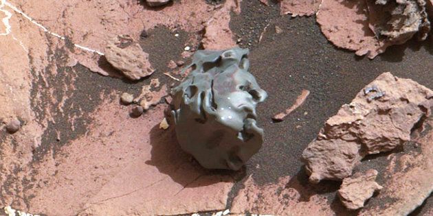 This image photographed by NASAs Curiosity Mars Rover on Oct 30 2016 shows a dark smoothsurfaced object After the golf ballsized object was examined by laser pulses from Curiosity it was determined to be an ironnickel meteorite The object has been nicknamed Egg Rock after an historic area of Bar Harbor Maine