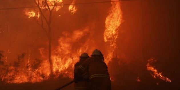 Firefighters battle out-of-control bushfire threatening properties in Sydney's West